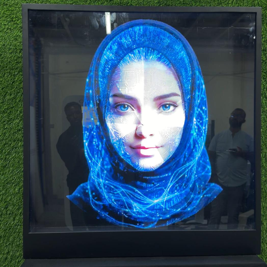 AI kiosk at an event features a digital display of a ai hologram woman in a blue hijab
